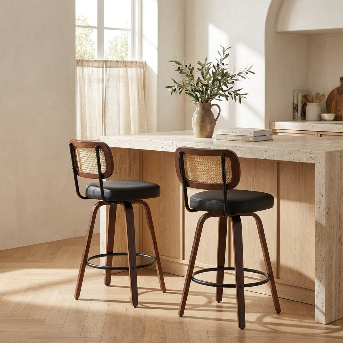 Two rattan counter stools at a travertine kitchen island