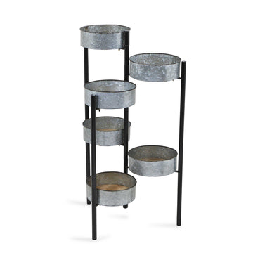 Metal plant stand with multiple circular shelves on a white background