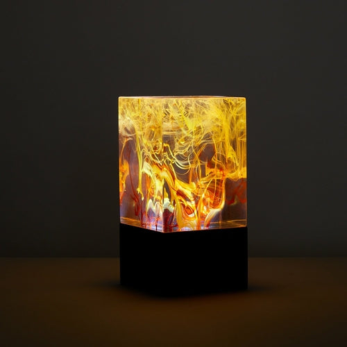 Decorative lamp with a colorful, abstract design on a dark background