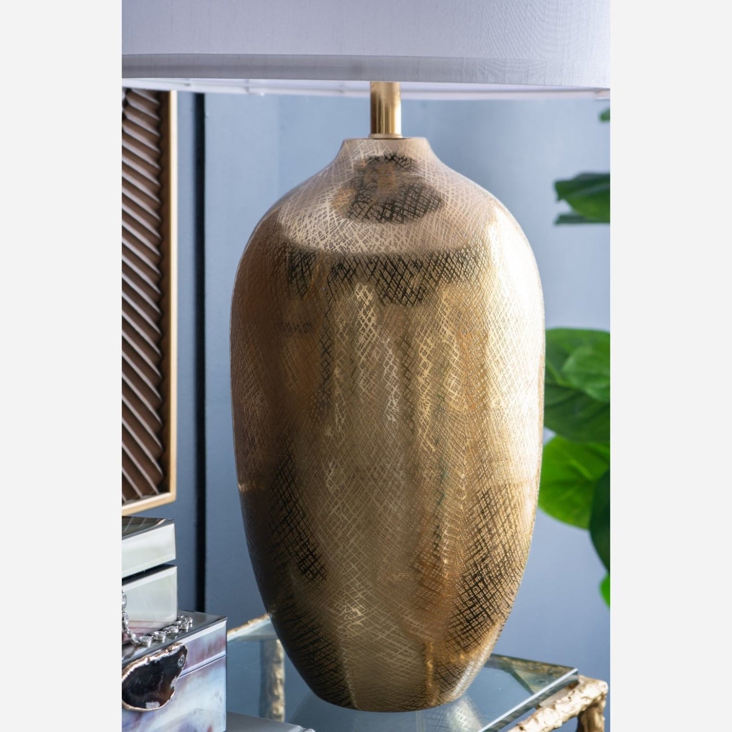 Decorative table lamp with textured surface on a reflective surface