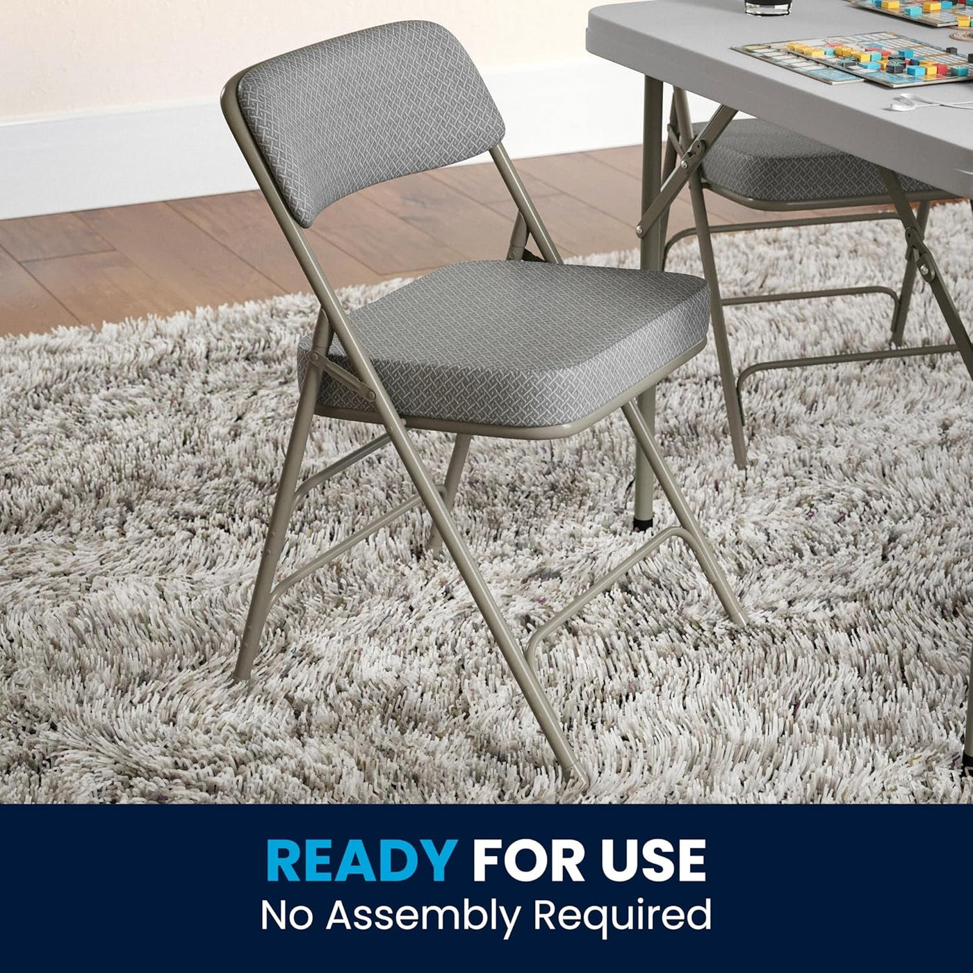 Gray folding chair on a shaggy rug with a table in the background