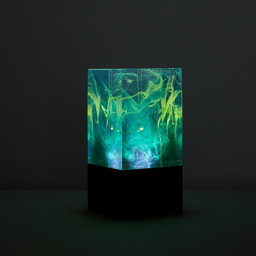 Luminescent container with green and blue smoke-like patterns on a dark background