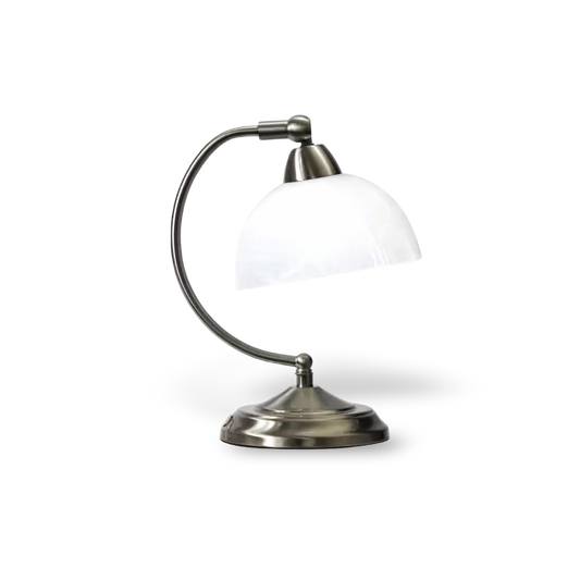 Table lamp with white glass shade and metallic base on a white background