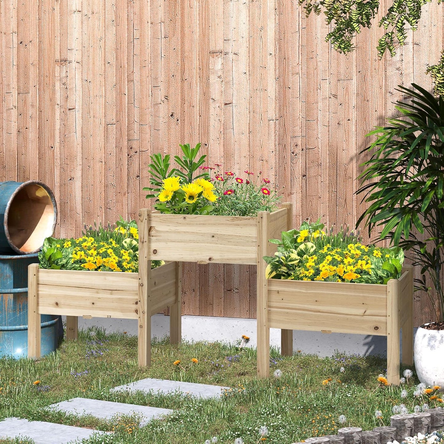 Wooden raised garden beds with plants against a wooden fence.