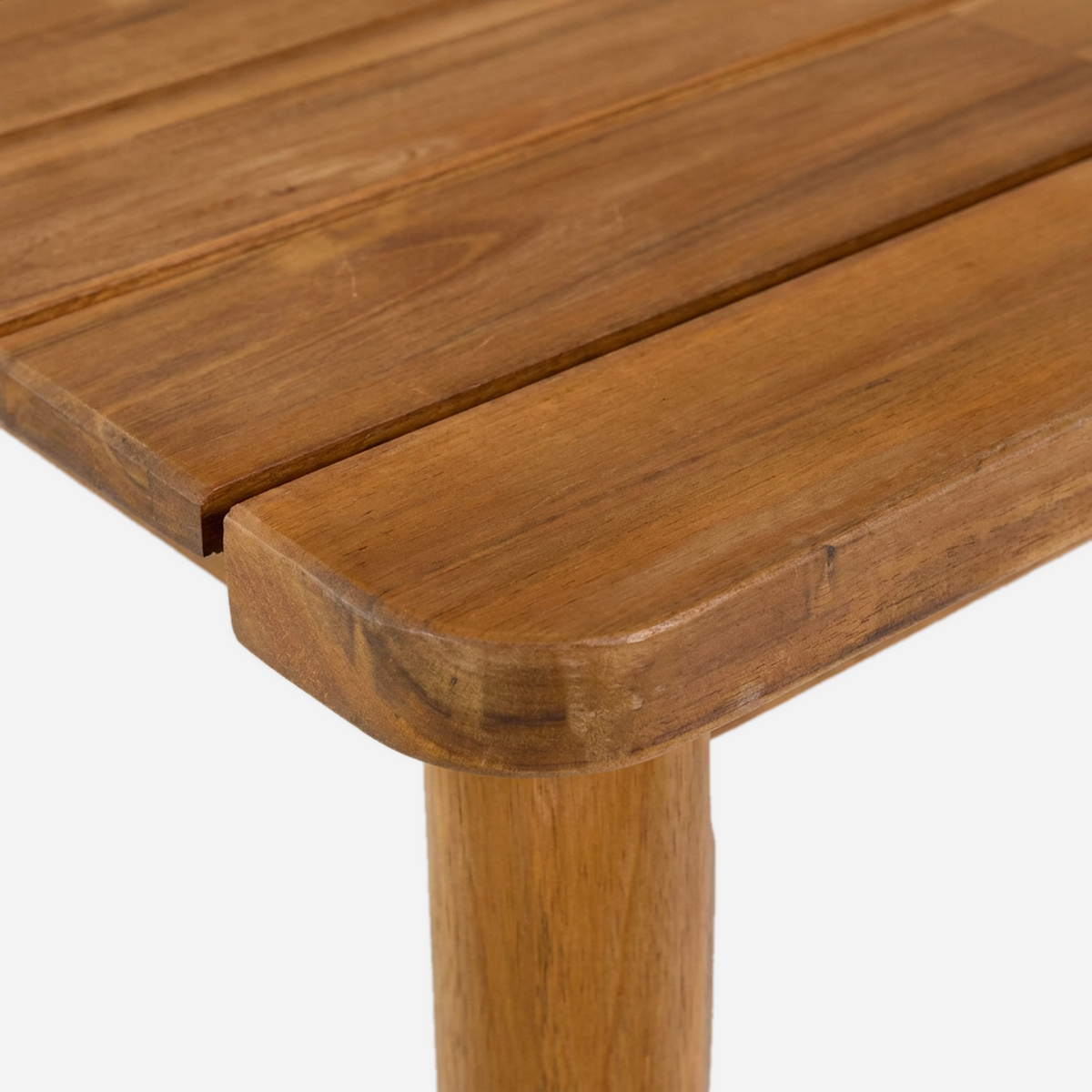 Close-up of the rounded slat corner above a tapered acacia table leg