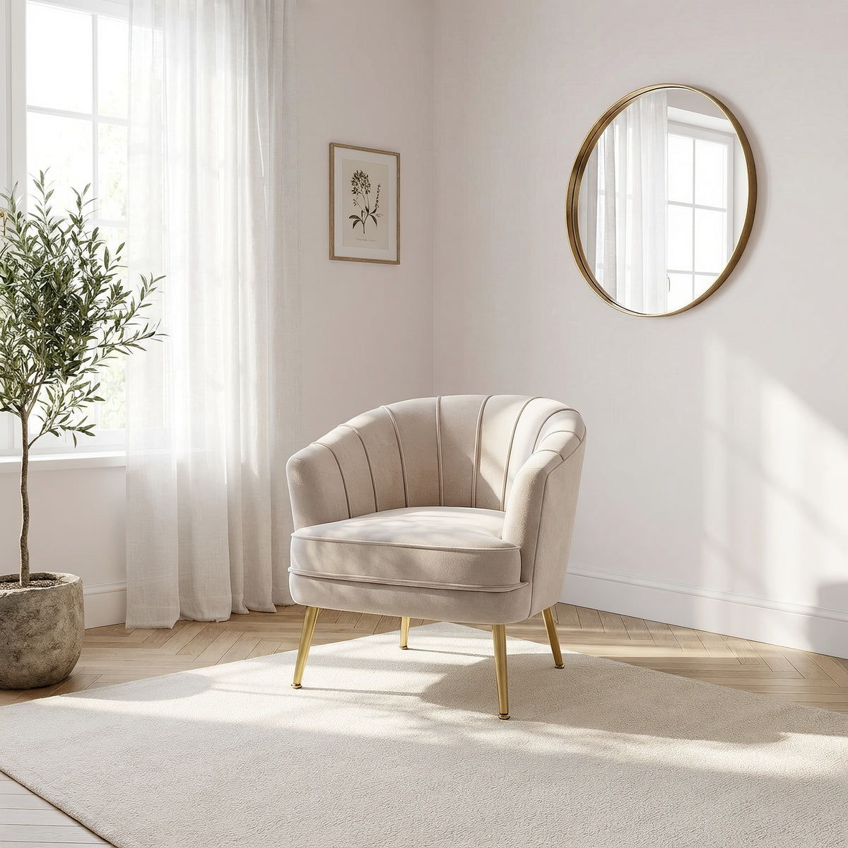 Beige velvet accent chair in a sunlit bedroom nook beside an olive tree and a round gold mirror