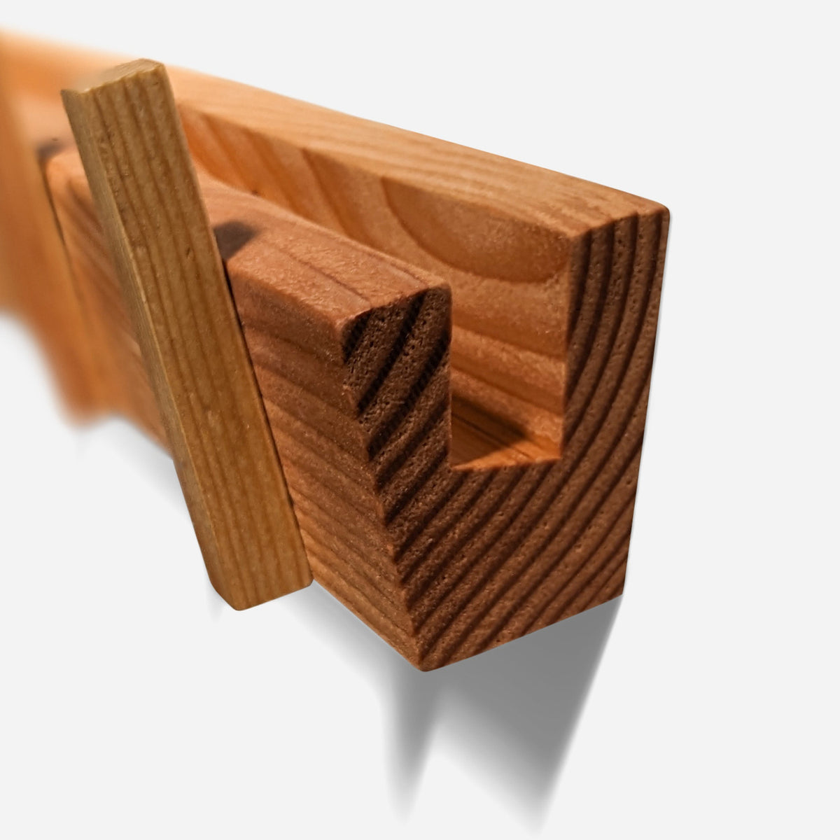 Stepped mail channel along the top of the board, seen end-on with the end grain of the fir (close-up detail)