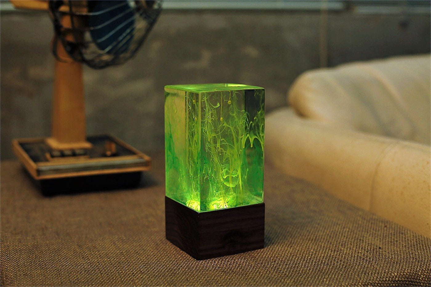 eplight Green glowing rectangular lamp on a textured surface with a blurred background