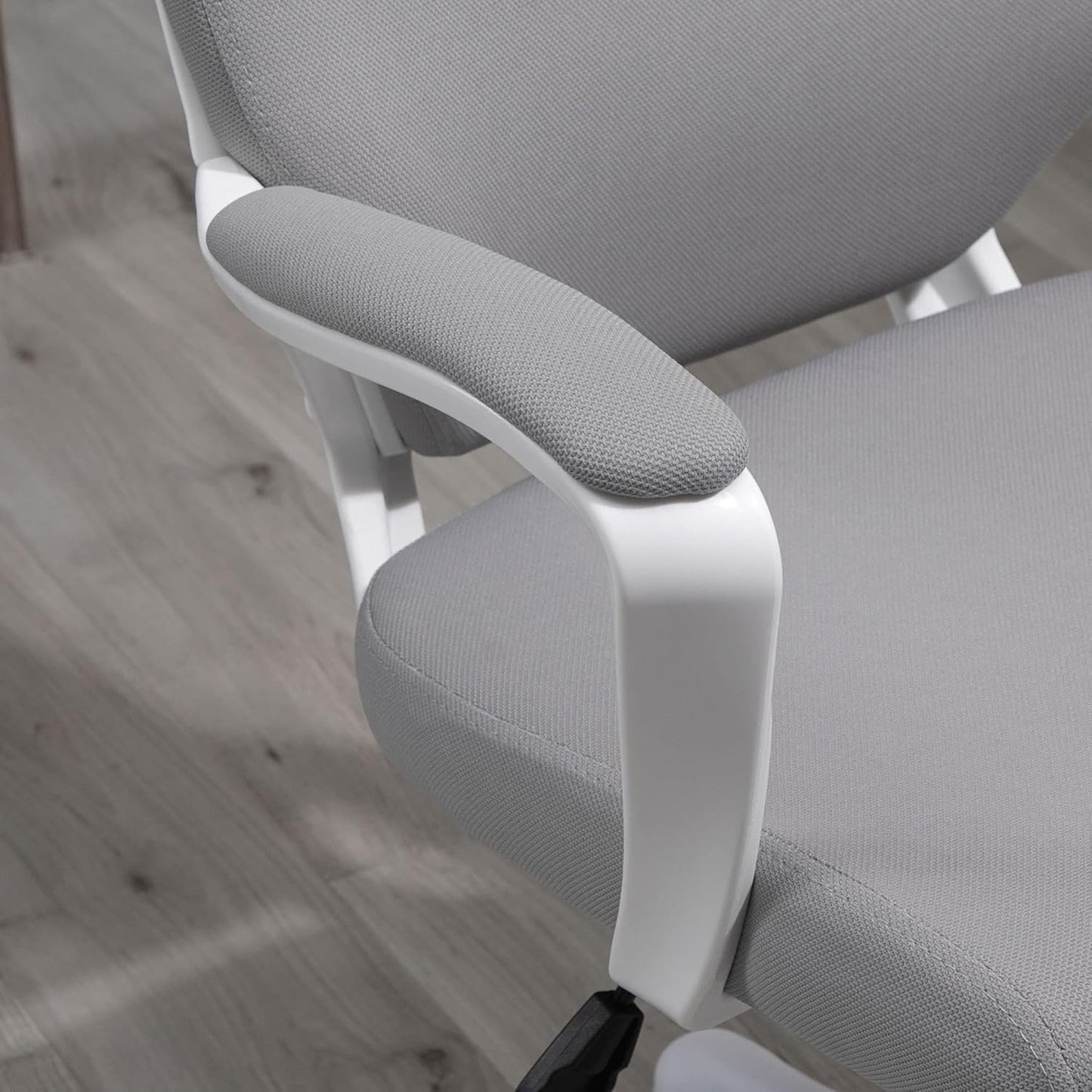 Gray office chair with white frame on a wooden floor