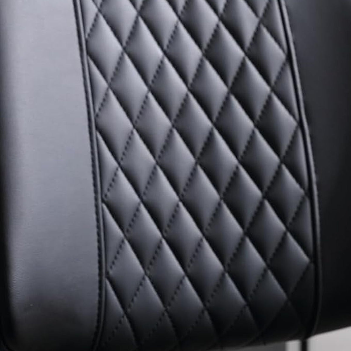 Diamond-quilted black PU leather backrest of the MCM office chair (close-up detail)