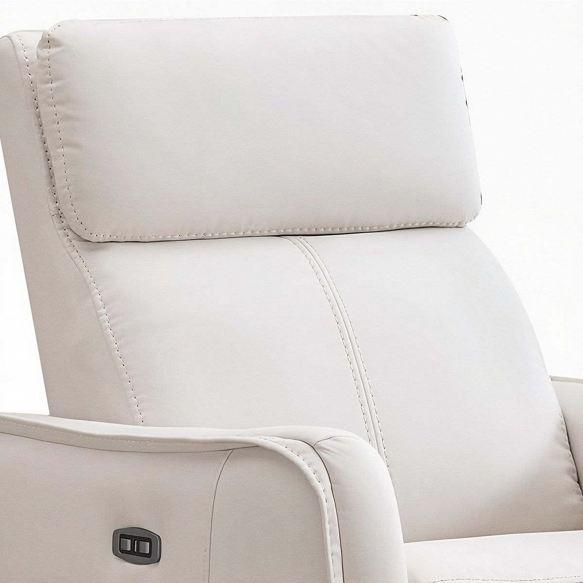 Stitched headrest and backrest seam of the cream recliner above the arm control (close-up detail)