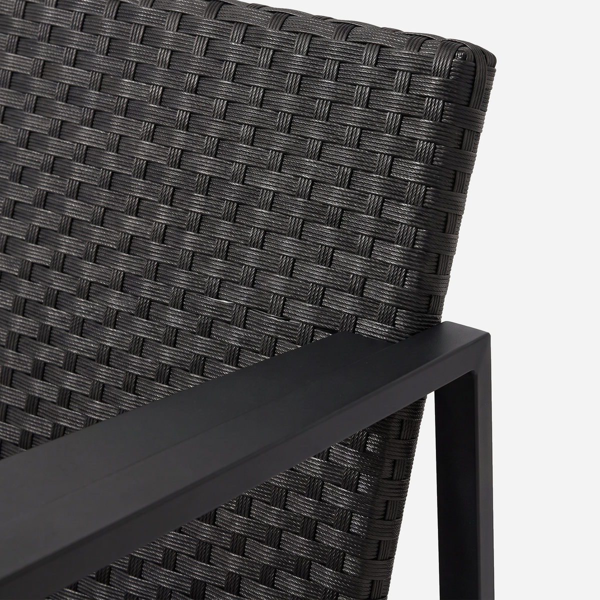 Close-up of the woven black rattan back on a rocking bistro chair
