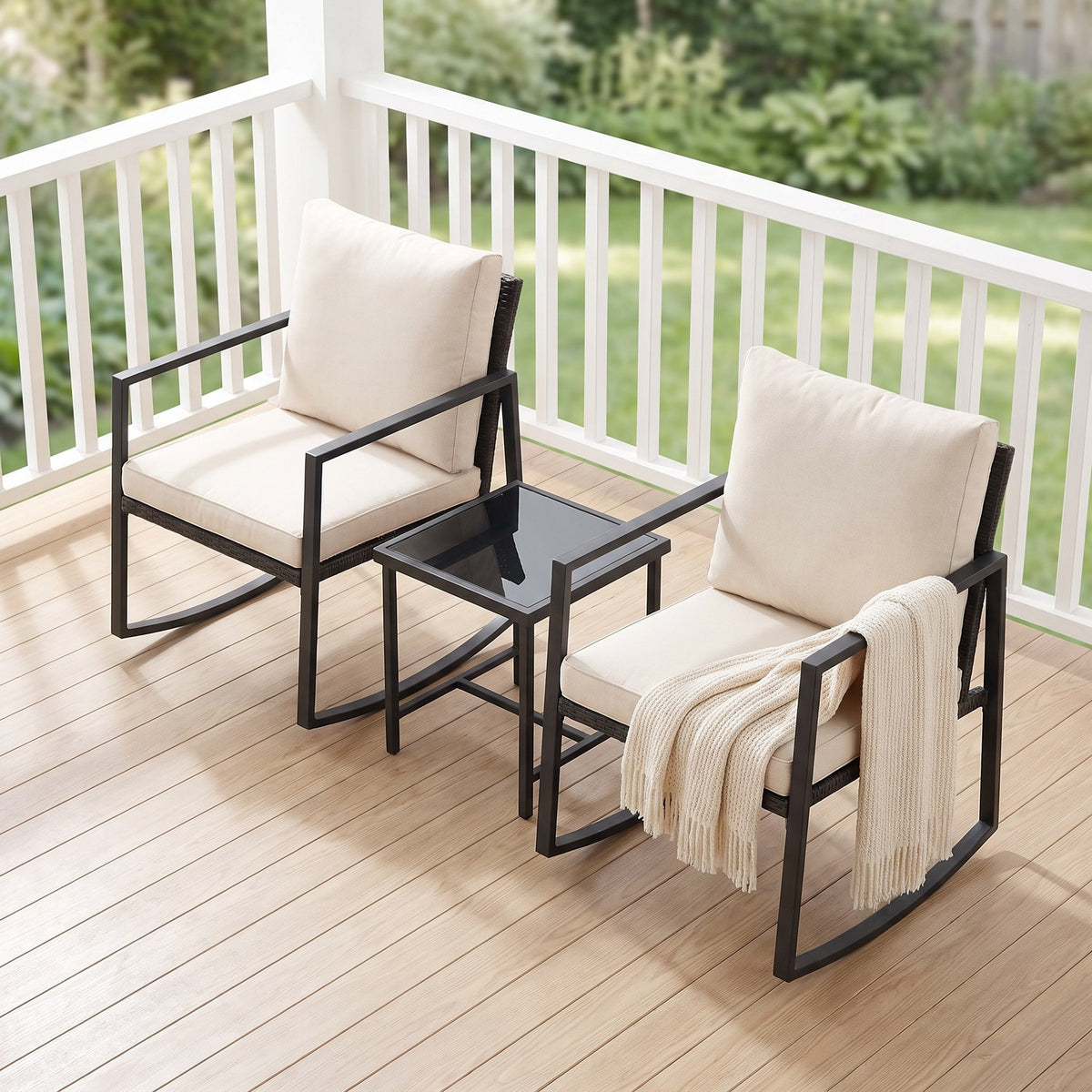 High view of the rocking chairs and glass-top table on a wooden deck