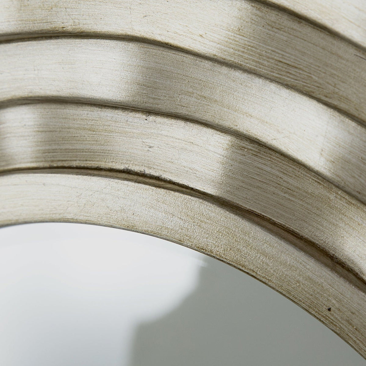Close-up of the bevel where the glass meets the sculpted silver frame