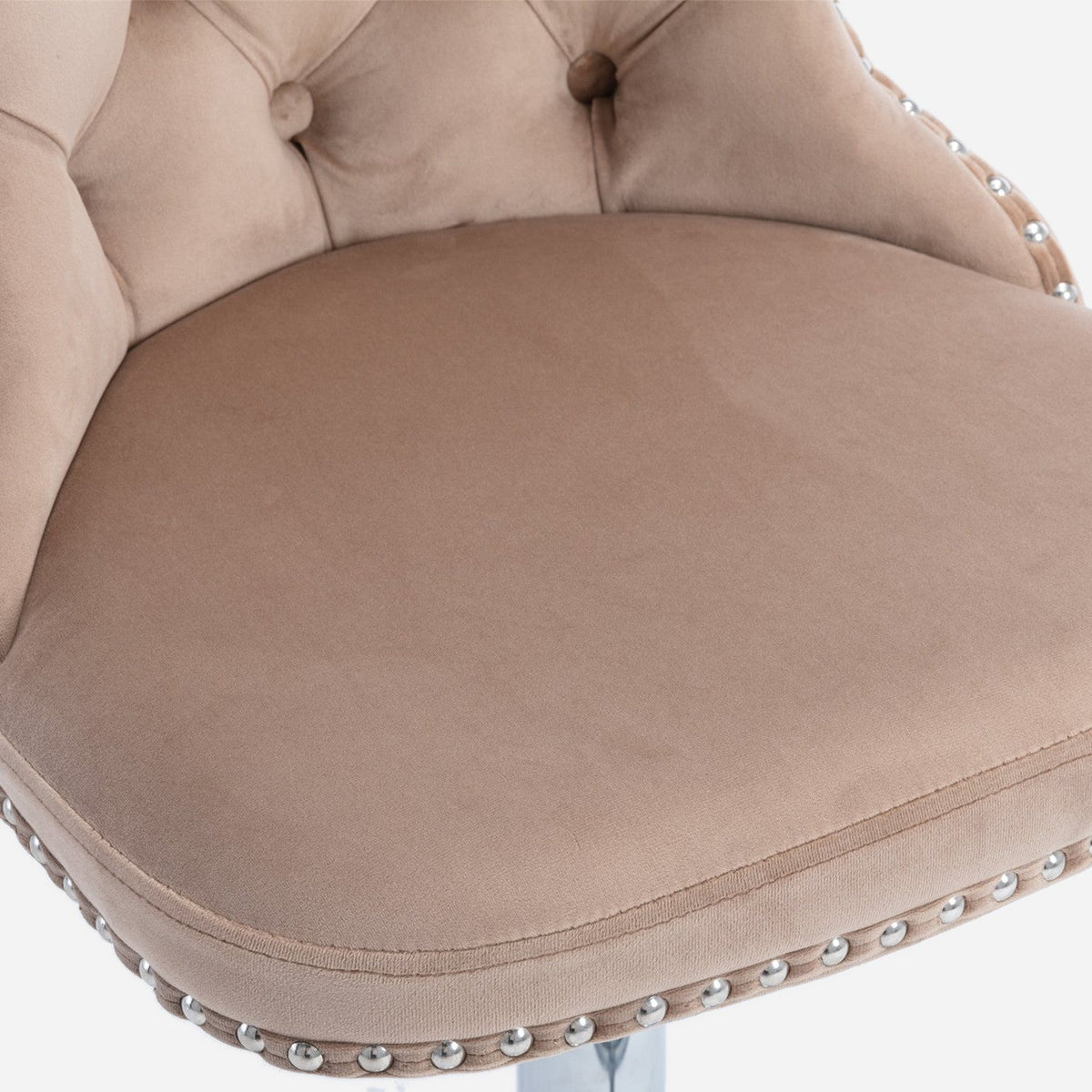 Padded khaki velvet seat with its nailhead row, close up