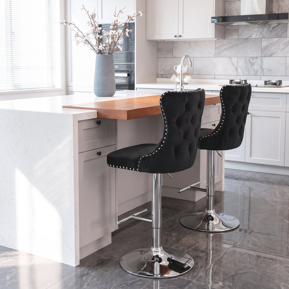 The same kitchen island seen along its length with both stools from behind