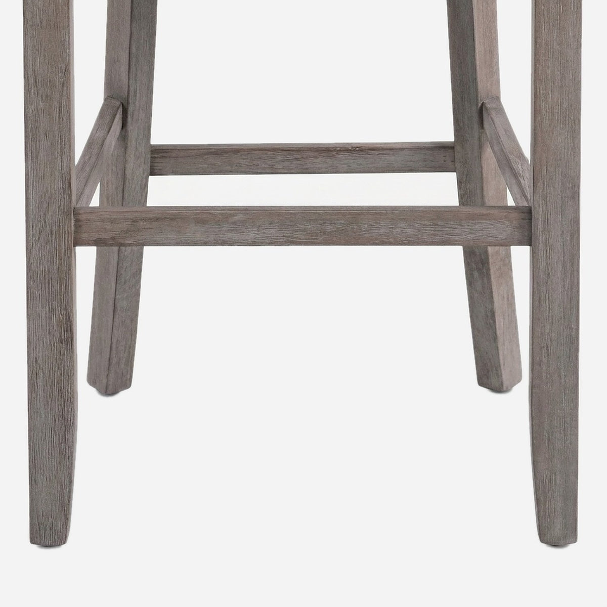Weathered rubberwood legs joined by footrest stretcher rails (close-up detail)