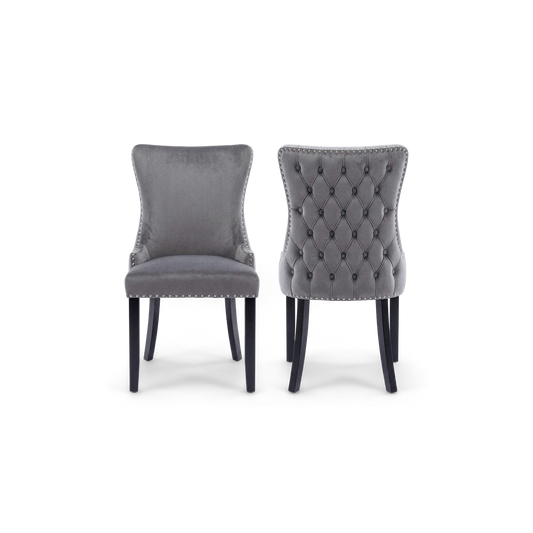 Pair of gray velvet wingback dining chairs with nailhead trim and black legs, front and back view (plain studio)