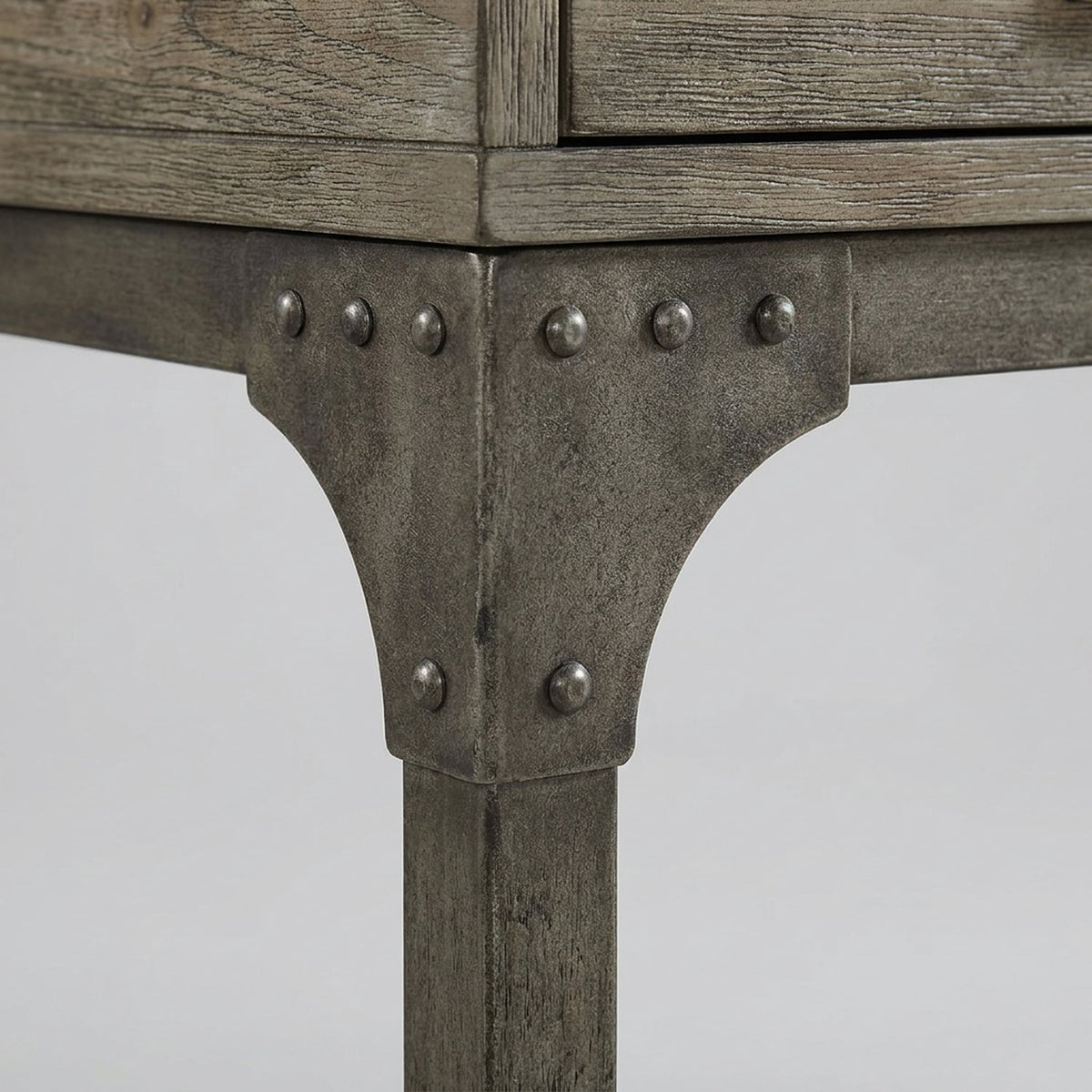 Riveted steel corner gusset on the desk frame (close-up detail)