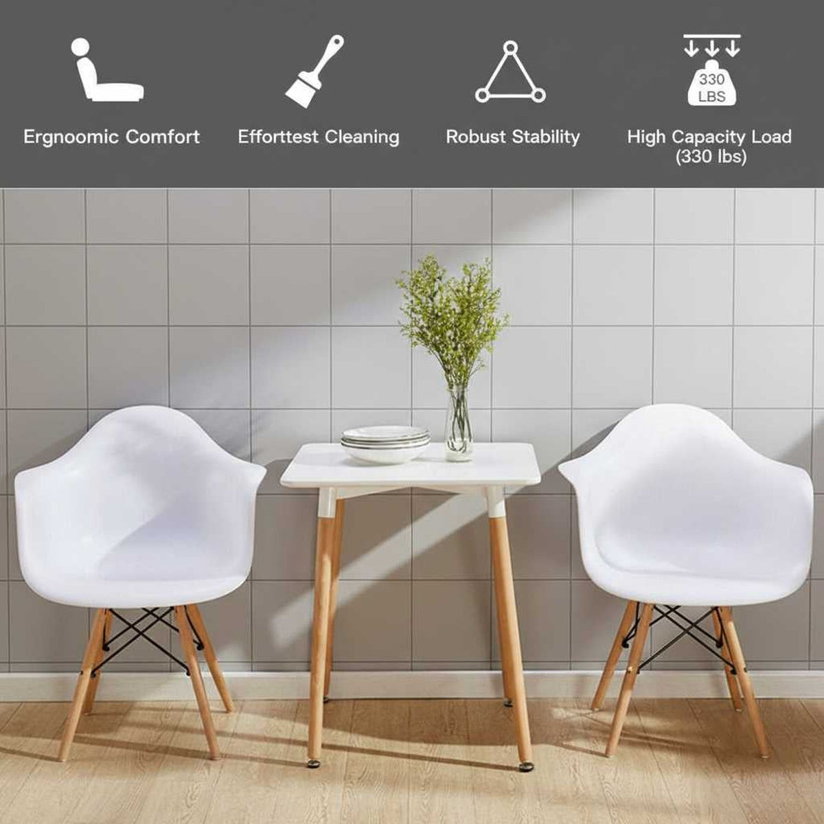 Set of 2 white mid-century molded dining arm chairs with wooden legs beside a small white table (feature callout)