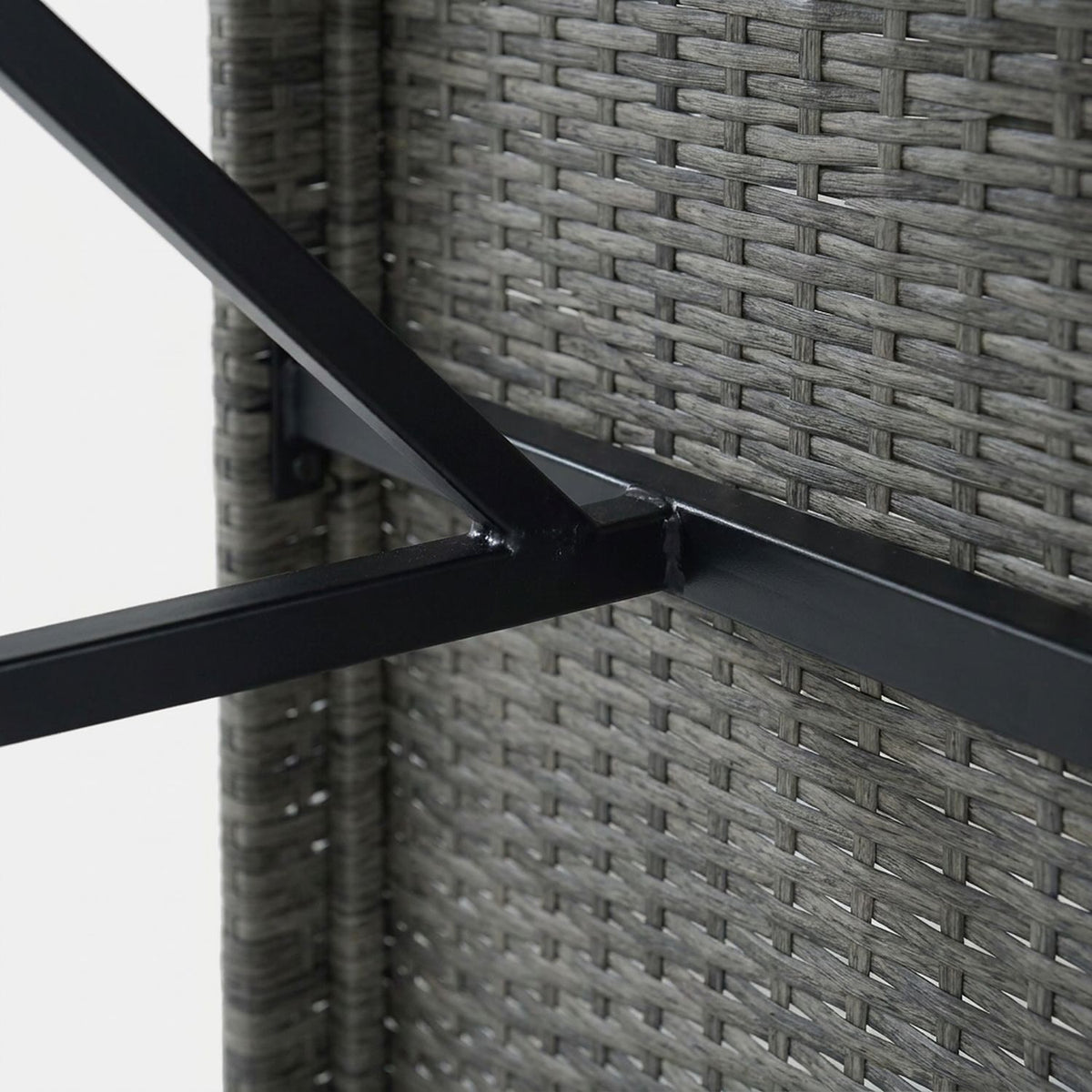 Black steel brace under the bar table against the wicker leg panel (close-up detail)