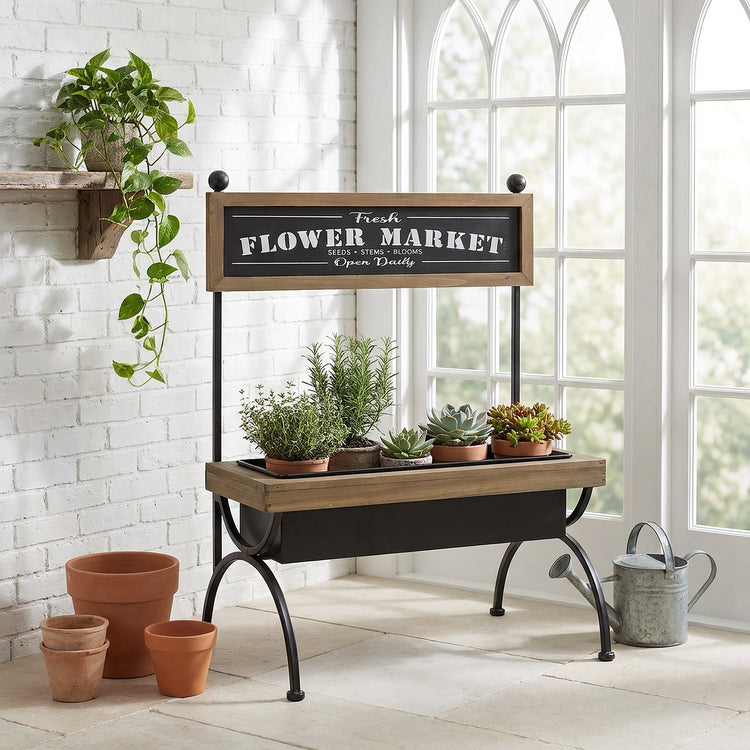 Wood and black iron flower market stand with potted herbs in a bright conservatory