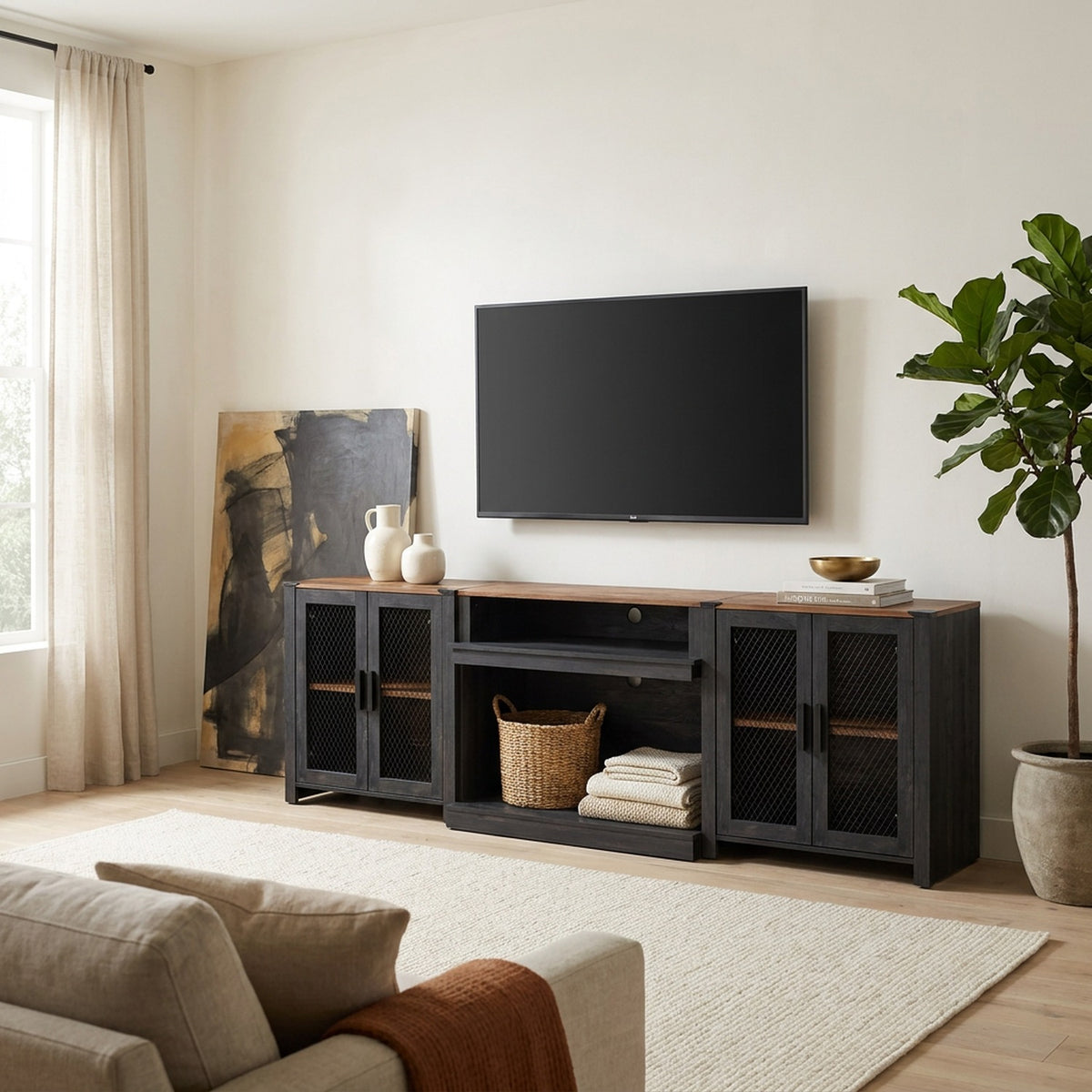 Black 100 inch tv stand with mesh doors and walnut-tone top beneath a wall-mounted TV in a bright living room