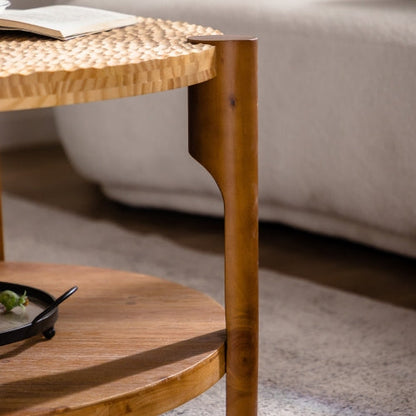 Round solid wood coffee table, leg and shoulder joint beside a sofa