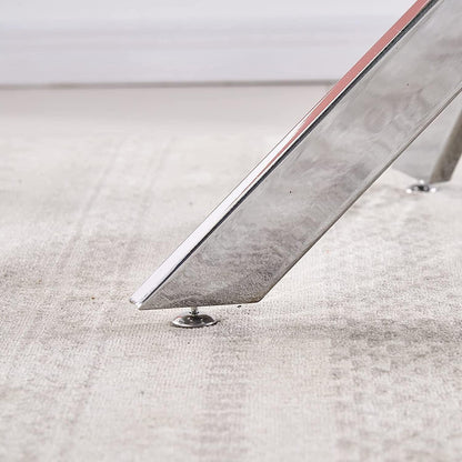 Close-up detail of an adjustable chrome foot resting on a pale woven rug