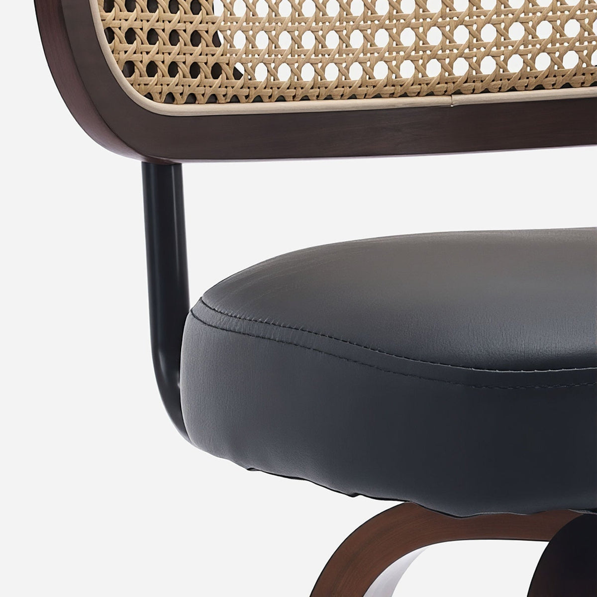 Close-up of the black back post bending under the seat into the walnut back