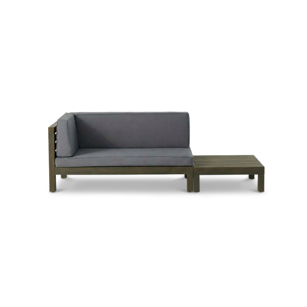 Acacia wood loveseat with dark grey cushions beside its matching slatted coffee table (plain studio)