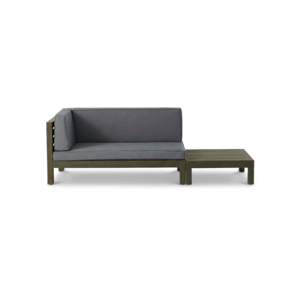 Acacia wood loveseat with dark grey cushions beside its matching slatted coffee table (plain studio)