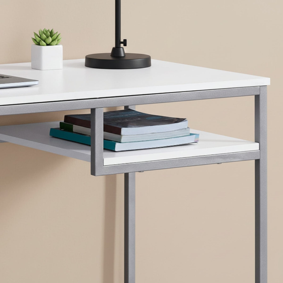 Durable 30inches White MDF and White Metal Computer Desk with a lower shelf holding books (close-up detail)