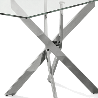 Close-up detail of the polished chrome legs crossing beneath the glass top