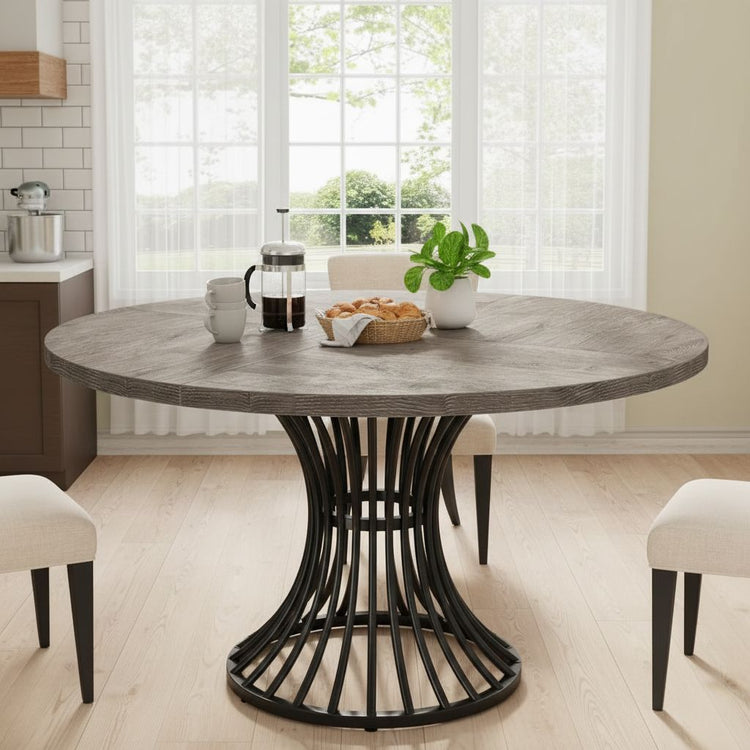 47-inch round grey dining table with a sculptural black base, seats 4-6 in the kitchen or living room.