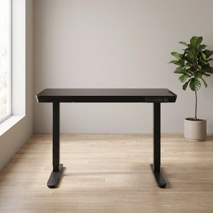 48 inch glass electric standing desk in a home office setting, front angle