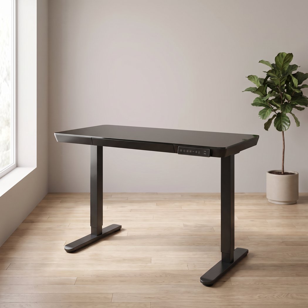 48 inch glass electric standing desk in a home office setting, three quarter angle