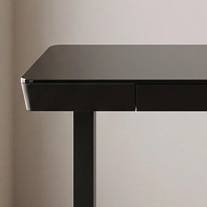 48 inch glass electric standing desk, front left desktop corner and drawer edge in a home office