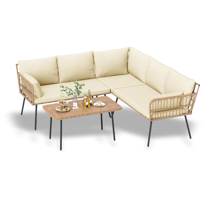 Beige sectional sofa with wicker armrests and a wooden coffee table on a white background