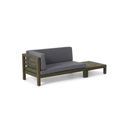 Acacia wood loveseat with dark grey cushions and slatted coffee table, angled view (plain studio)