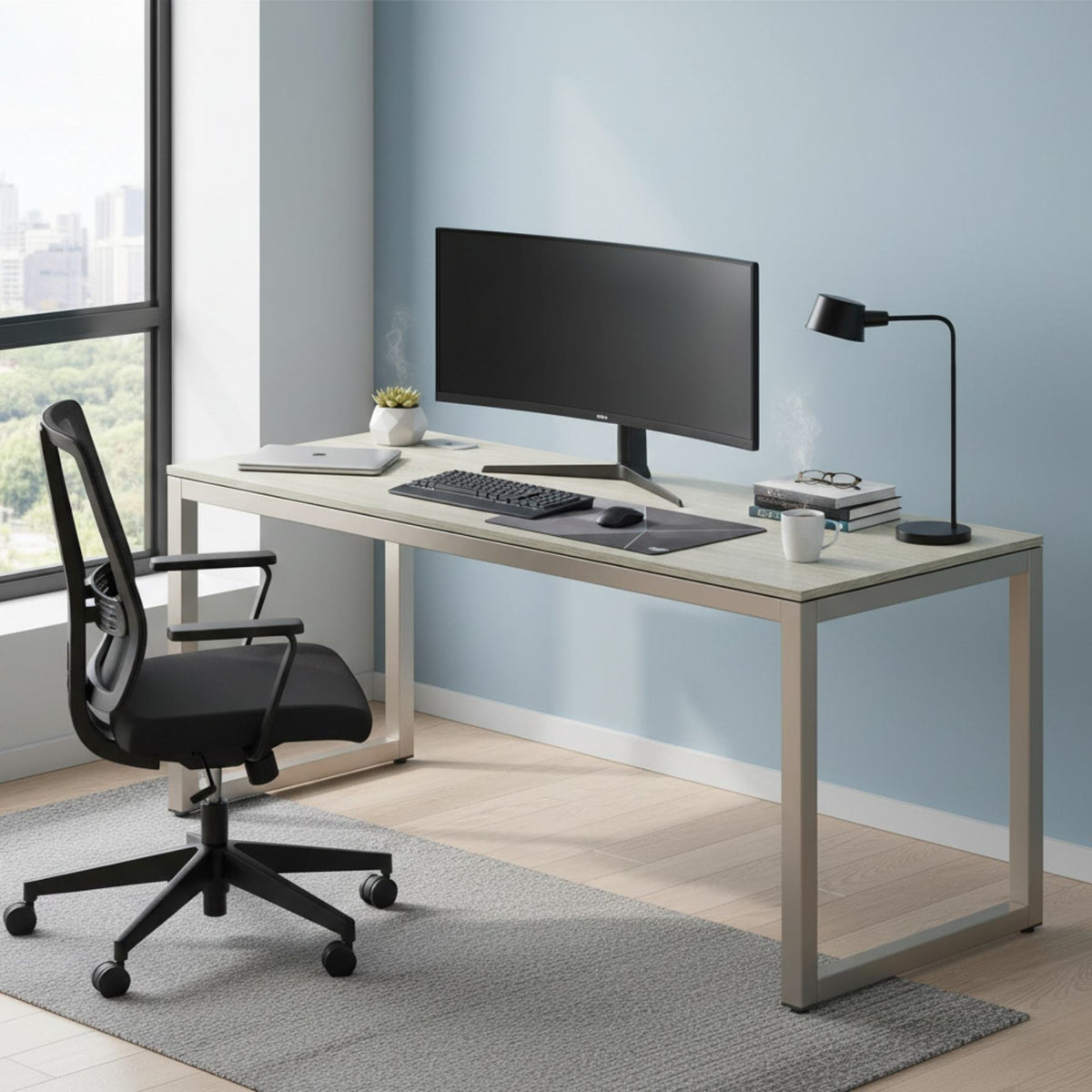 The desk along a blue wall in a city-view workroom, ultrawide monitor, keyboard and black task chair on a grey rug