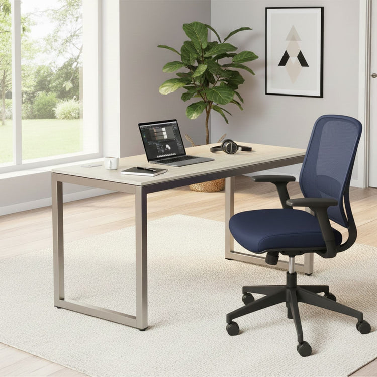 55 Inch maple computer desk with grommets and glides in a modern home office, with a laptop and blue ergonomic chair.