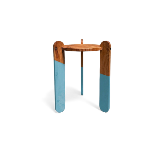 Colorful dipped-leg accent table with blue legs, straight-on view (plain studio)