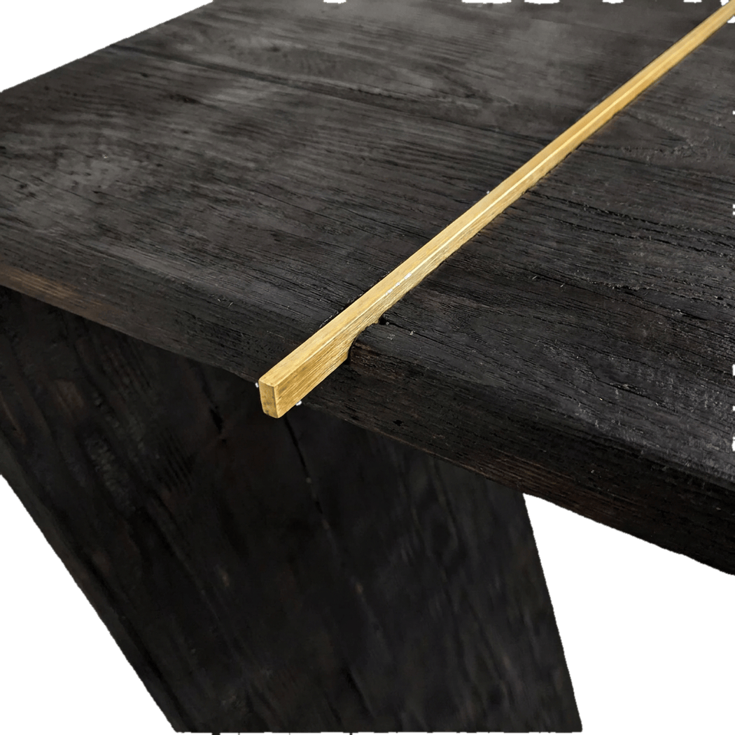 close-up of the brass rod end on the torched black top (plain studio)