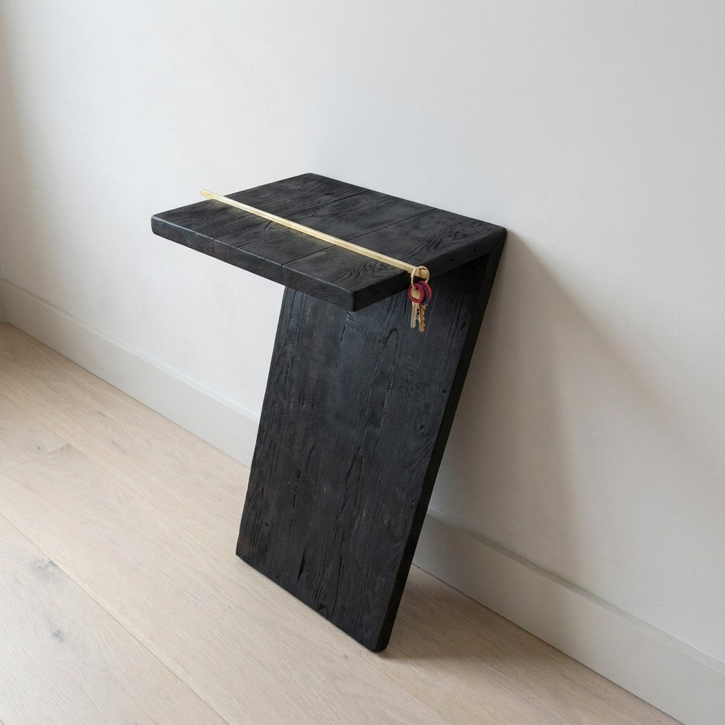 7 console table leaning on an entryway wall with keys hanging on the brass rod