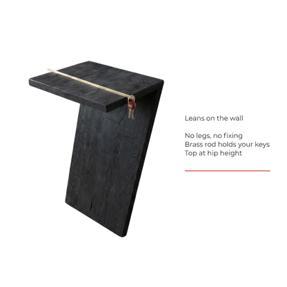 leans on the wall, no legs, brass rod holds your keys (feature callout)