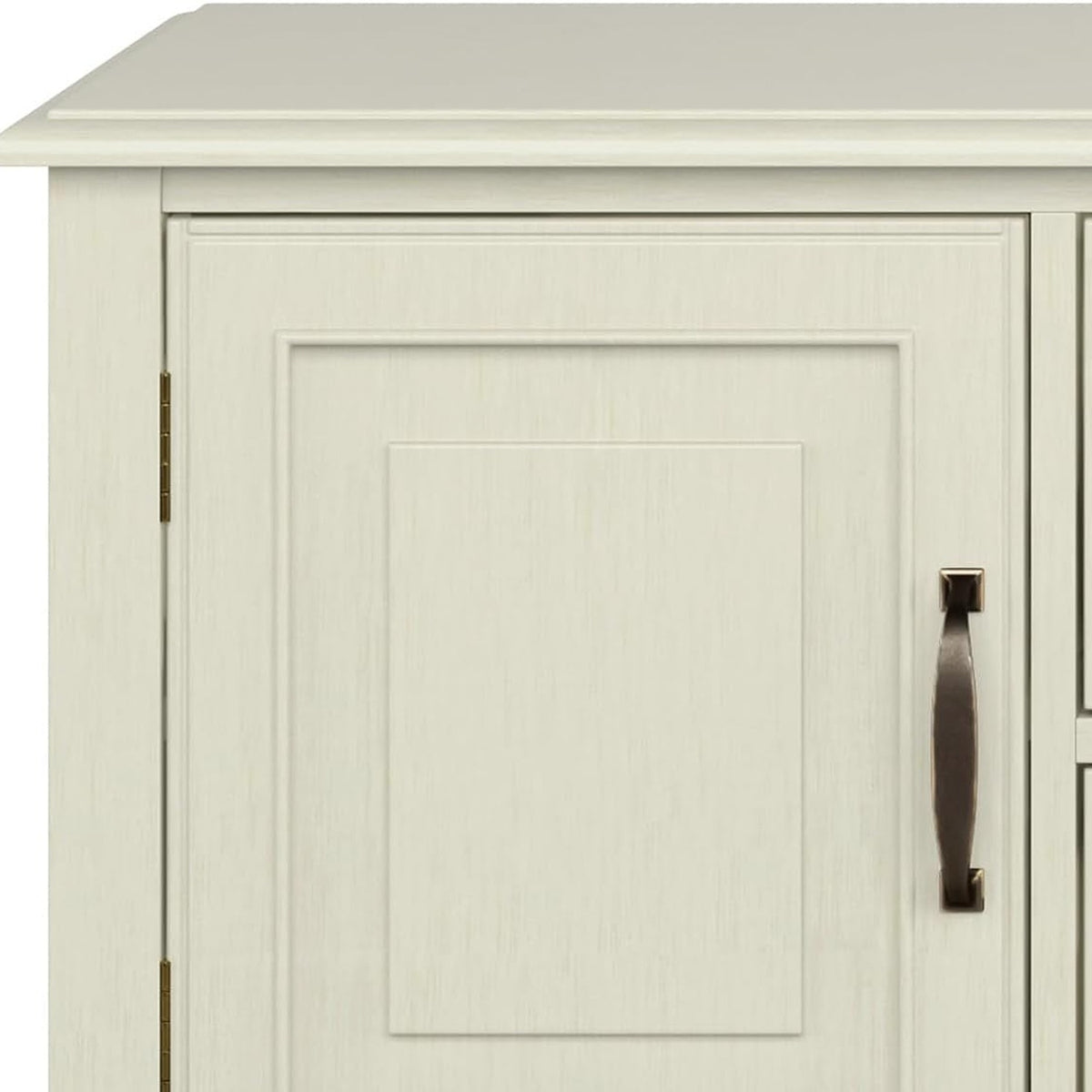 Raised-panel white door with a bronze bow handle on the inner edge (close-up detail)
