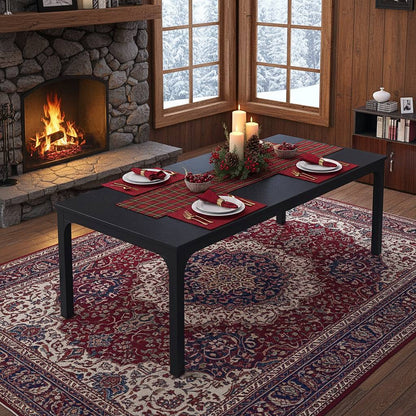 78-inch black rectangle dining table for 6–8 with plaid runner and candle centerpiece by a stone fireplace.