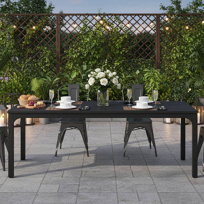 78-inch black rectangular dining table set for six to eight outdoors with a white centerpiece.