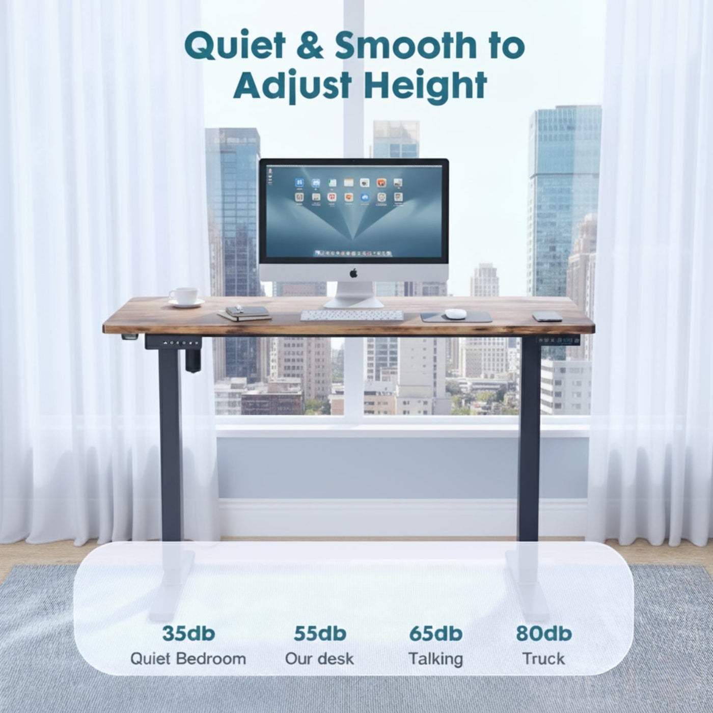 Adjustable height desk with a computer monitor in a room with large windows.